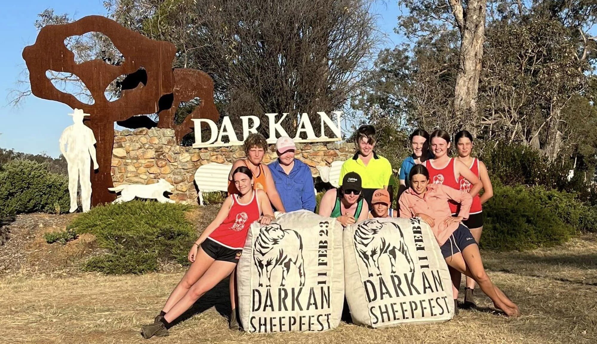 Young volunteers with stencilled wool bales at the Darkan town entry statement